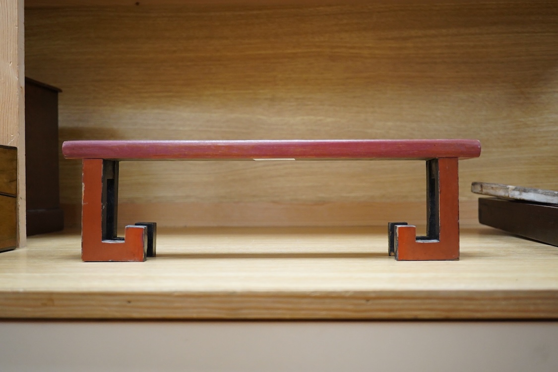 A Chinese red lacquered stand, 39cm wide